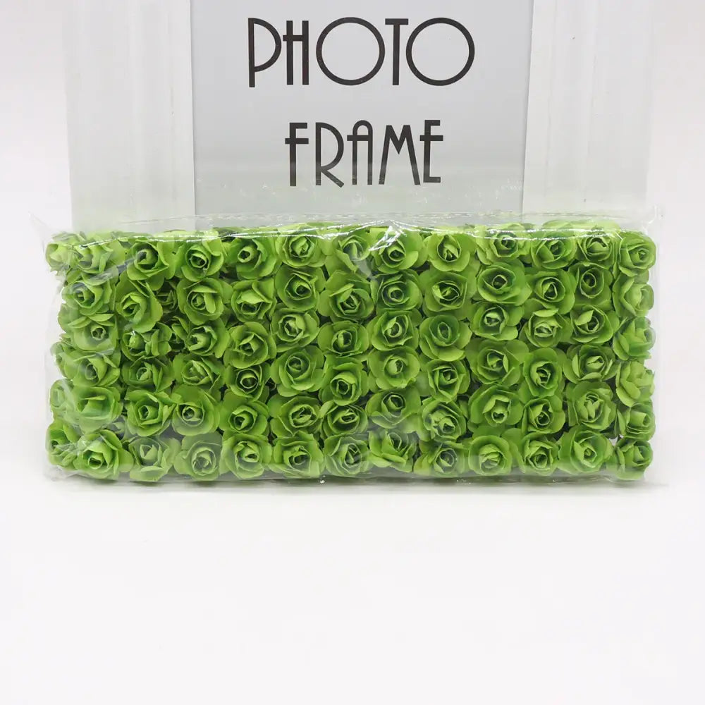 A package of vibrantly green decorbites 144pcs 2cm artificial paper roses neatly arranged for wedding decor or bedroom use