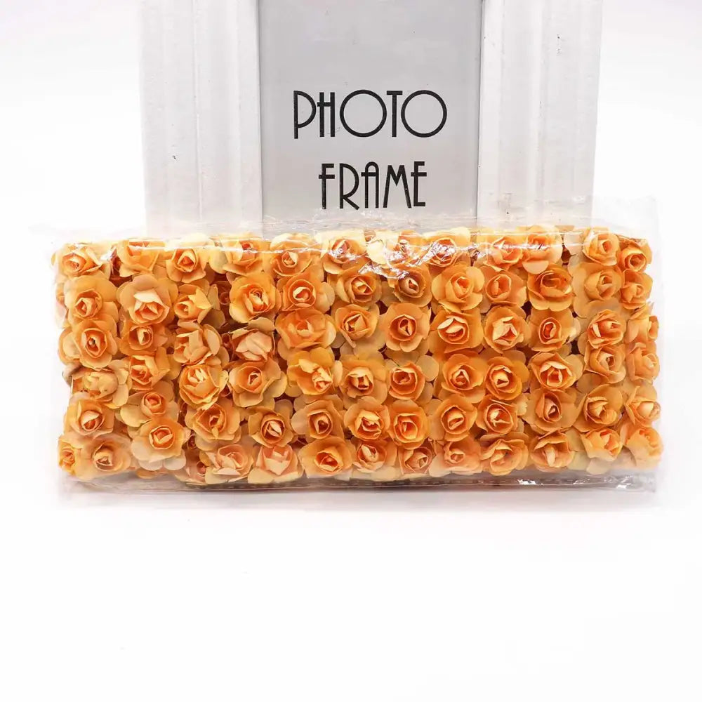 A package of orange decorbites 144pcs 2cm artificial paper roses neatly arranged and sealed for wedding decor