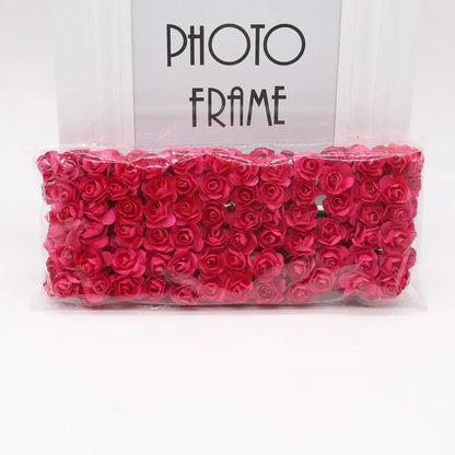 A package of decorbites 144pcs 2cm vibrant red 2cm artificial paper roses neatly arranged and sealed in clear plastic