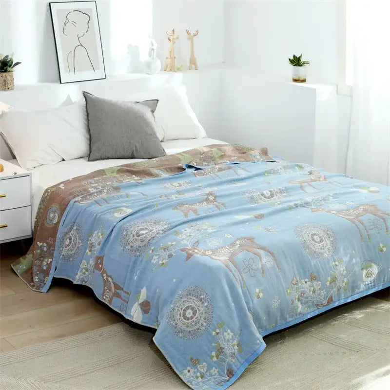 Light blue fleece blanket with cozy deer and floral pattern in earthy tones featured in decorbites boho printed style
