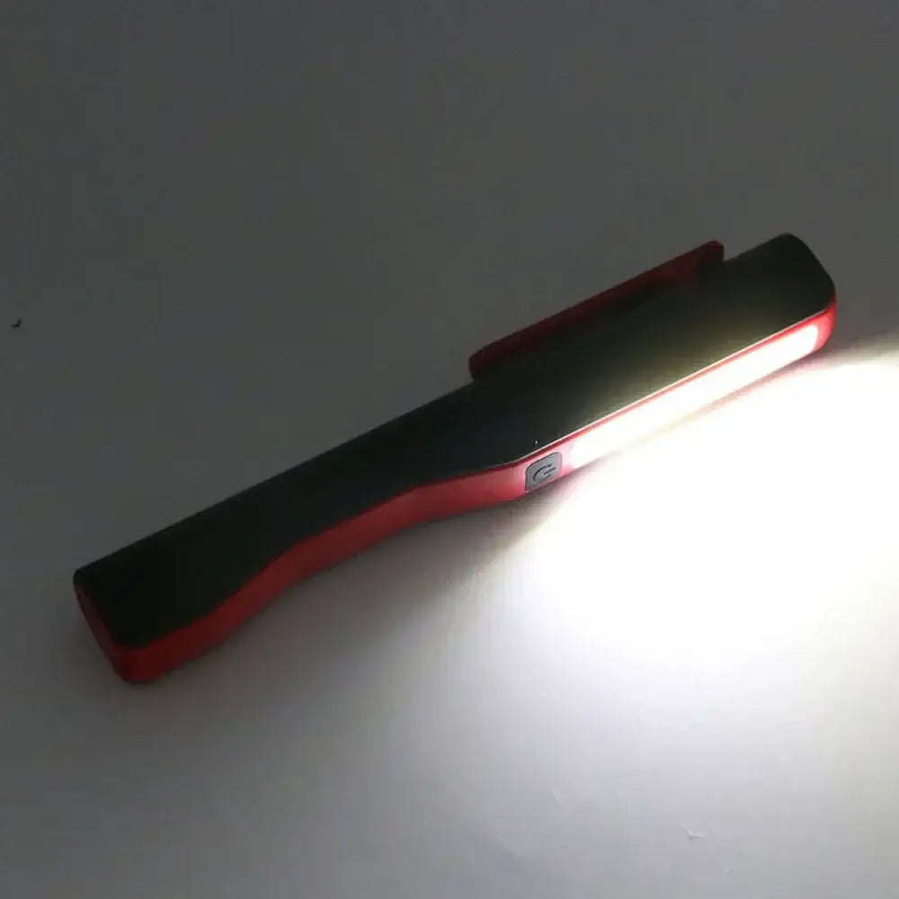 Red and black decorbites cob led flashlight with clip-on design for versatile garage and work light use