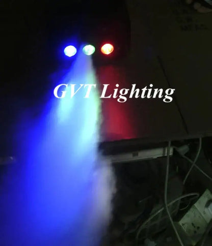 A multicolor led stage smoke machine with remote emitting vibrant blue green and red beams through stage smoke for parties