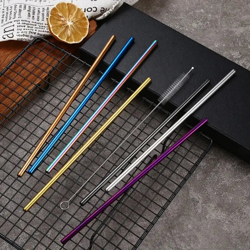 Set of multicolor stainless steel reusable straws in gold blue purple and silver with a cleaning brush for kitchen use