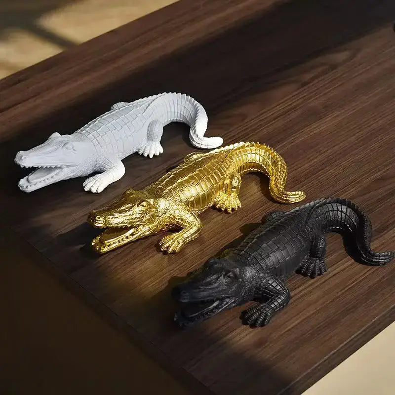Three resin crocodile wildlife sculpture figurines in white gold and black with detailed scales for living room decor