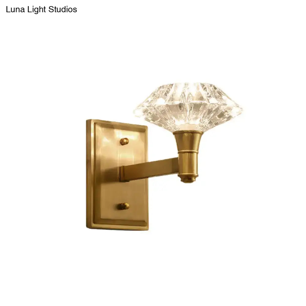 Brass-finished wall mounted bedroom wall lamp with faceted crystal lampshade suitable as a doorway wall lamp