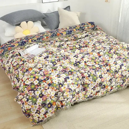 Colorful floral-patterned cotton throw blanket with fringe border featuring decorbites gauze flowers on light background