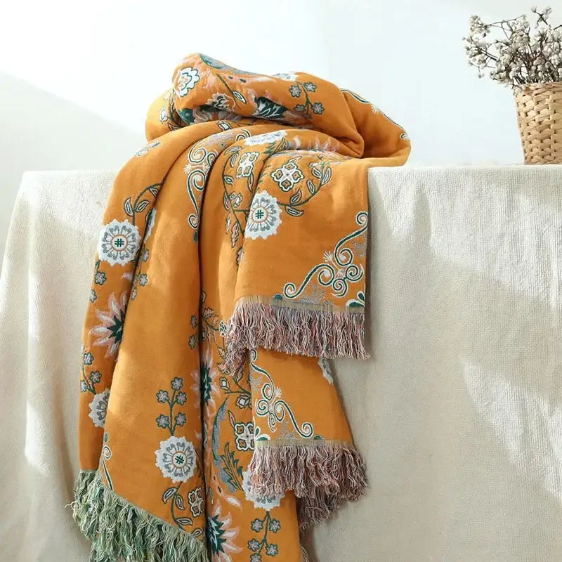 Mustard and teal cotton throw blanket with decorbites gauze flowers pattern and fringed edges for bedroom decor