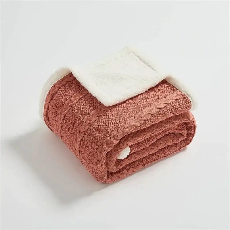 A cozy terracotta cable knit sherpa blanket with plush white lining from decorbites for bedroom decor