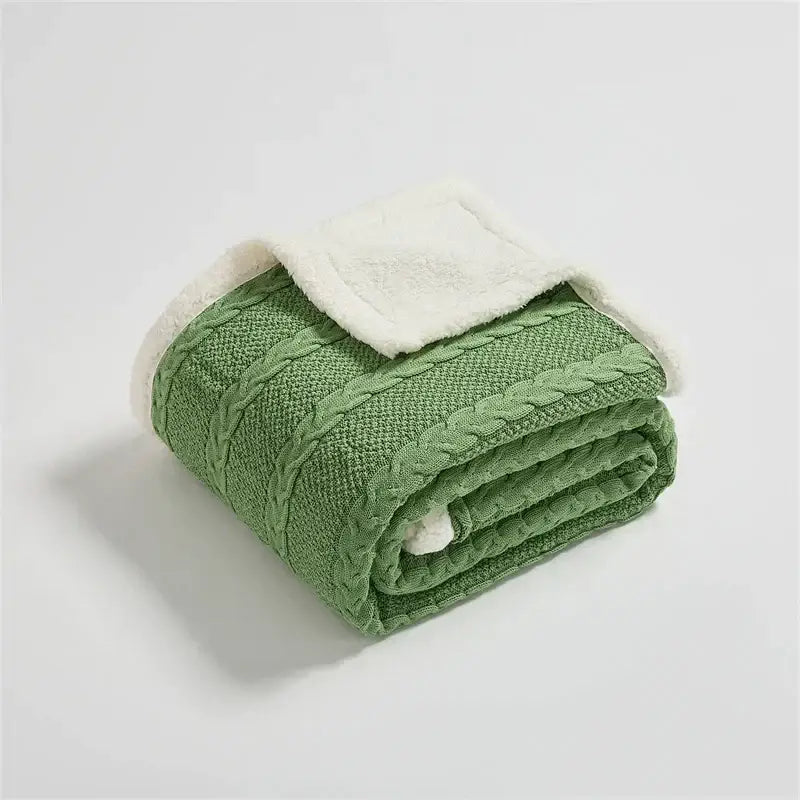 A cozy green decorbites cable knit sherpa blanket with plush white lining for bedroom throw and warmth
