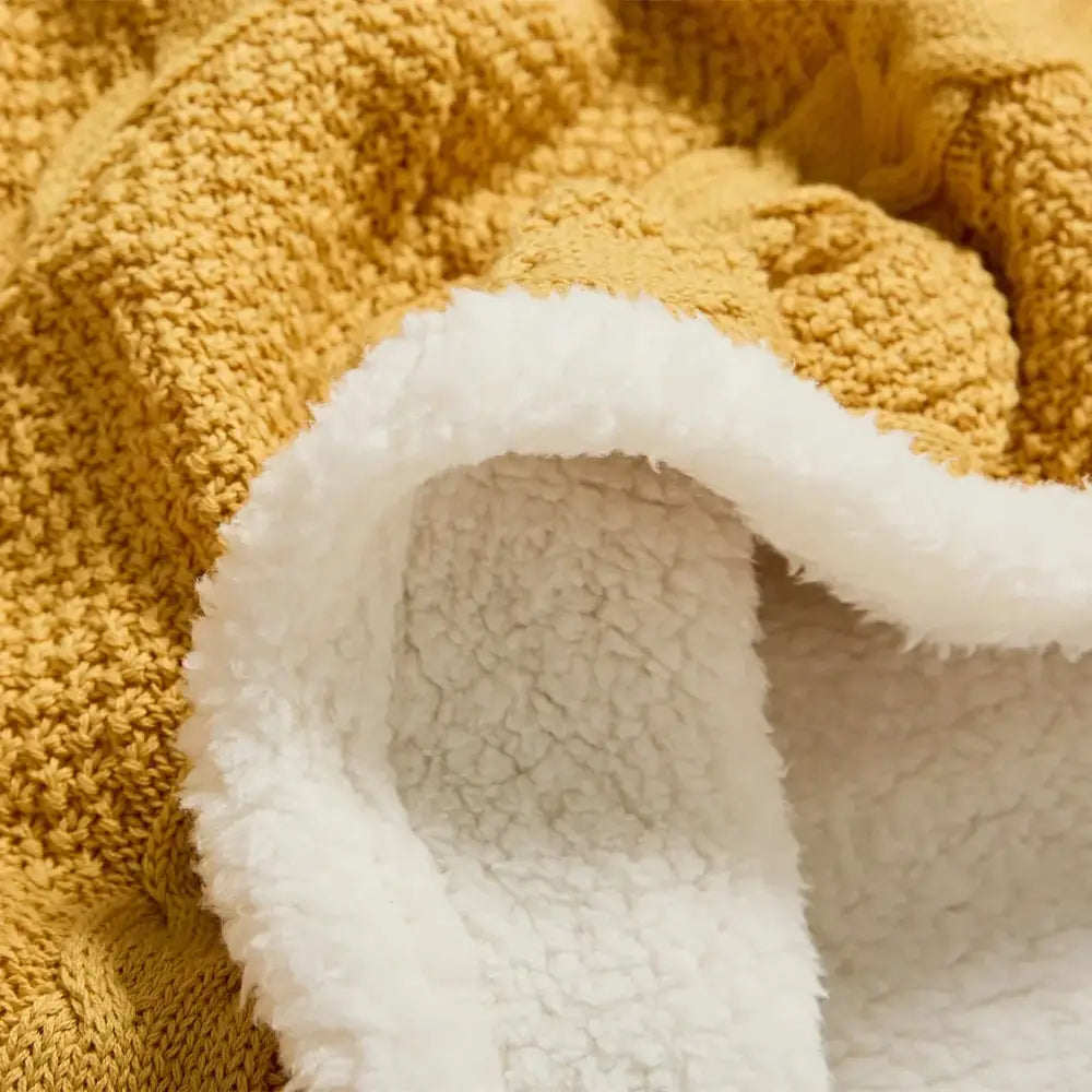 Warm mustard yellow cable knit sherpa blanket with plush white sherpa lining by decorbites for cozy decor