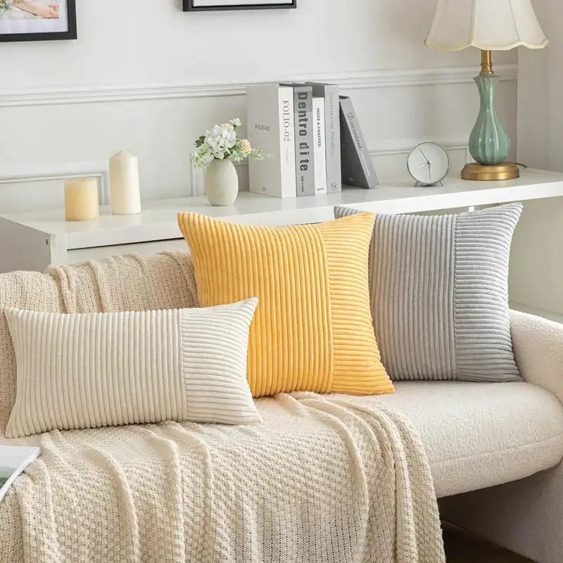 Three corduroy throw pillow covers in cream mustard yellow and gray with vertical striped patchwork texture by decorbites