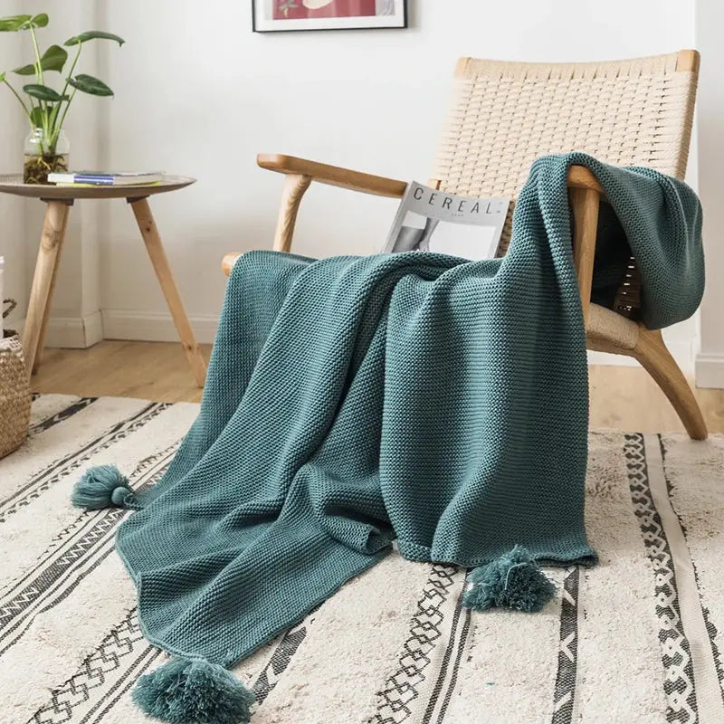 Teal knitted throw blanket with textured weave and matching tassels perfect for decorbites knit pompom tassel decor