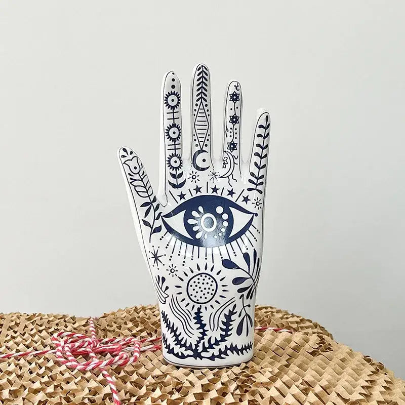 Mystic white and blue ceramic hand jewelry holder stand with intricate navy eye and floral patterns for bedroom decor