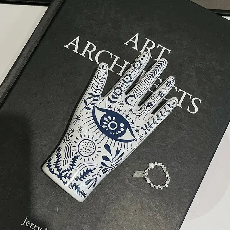 Mystic white and blue ceramic hand jewelry holder stand with intricate patterns and central eye motif for bedroom decor