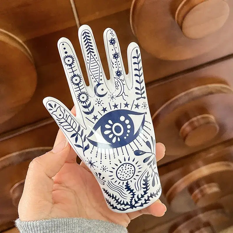 Mystic white and blue ceramic hand jewelry holder stand with intricate eye and floral patterns for bedroom decor
