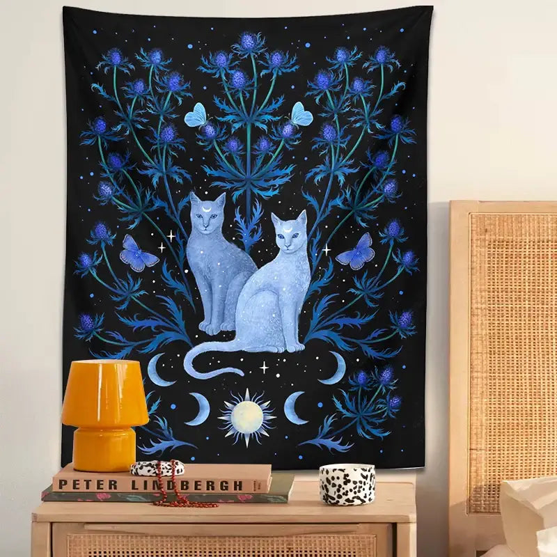 Mystical black and blue decorbites cat tapestry wall hanging with light blue cats, blue thistle plants, butterflies, and celestial symbols