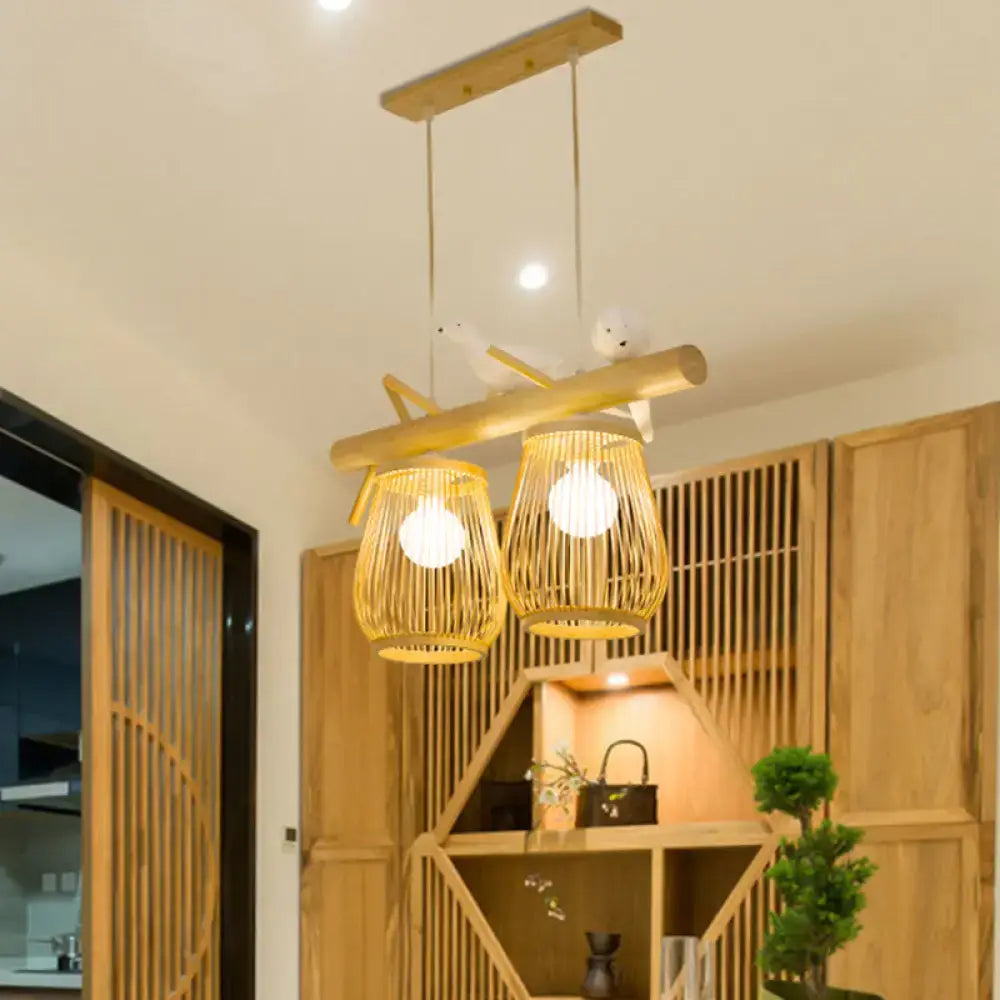 Natural bamboo barrel pendant lights with two woven lanterns and wooden crossbar for dining room island lighting