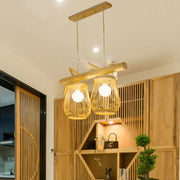 Natural bamboo barrel pendant lights with two woven lanterns and wooden crossbar for dining room island lighting