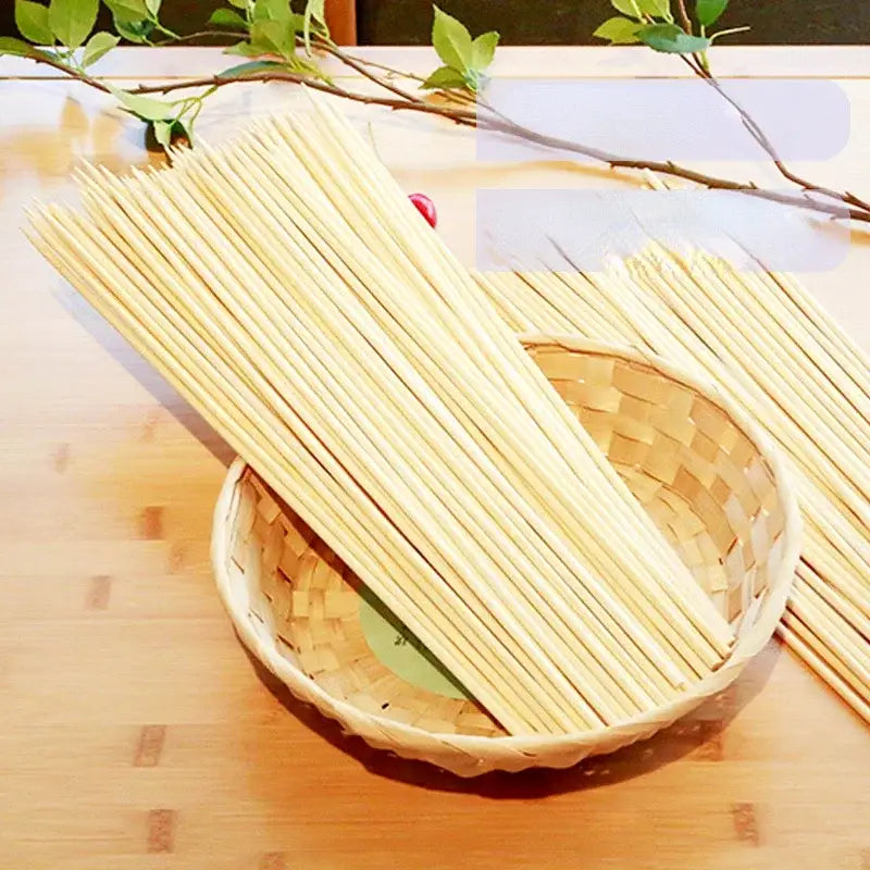 A bundle of light beige natural bamboo bbq skewers neatly arranged in a woven wicker basket for kitchen grilling