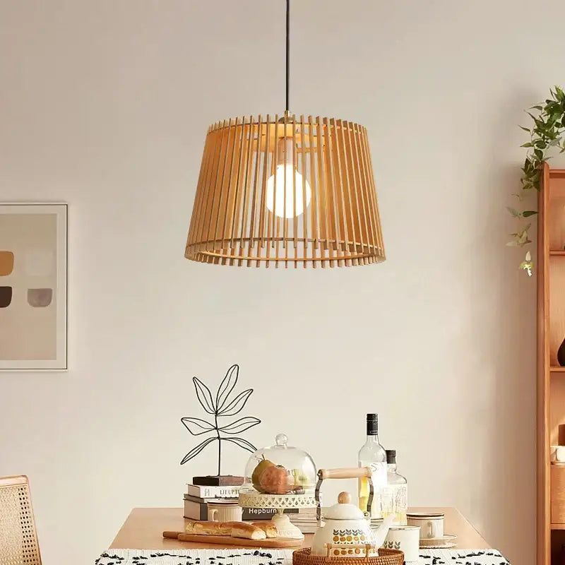 Natural warm-toned bamboo pendant lamp with cylindrical slatted design and visible bulb for living room decorbites birdcage chandelier