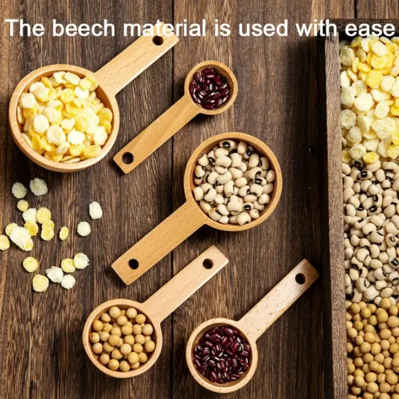 Set of five natural beech wood tablespoon coffee scoop kitchen spoons holding dried beans and grains