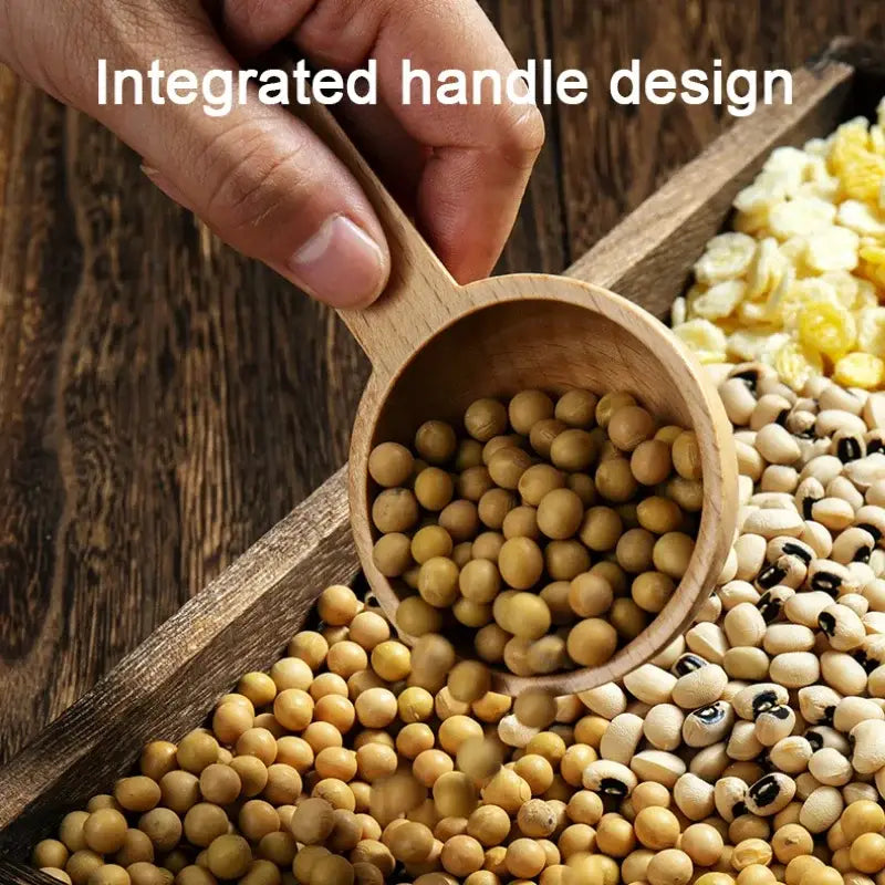 Light brown beech wood tablespoon coffee scoop with integrated handle filled with yellow soybeans for kitchen use