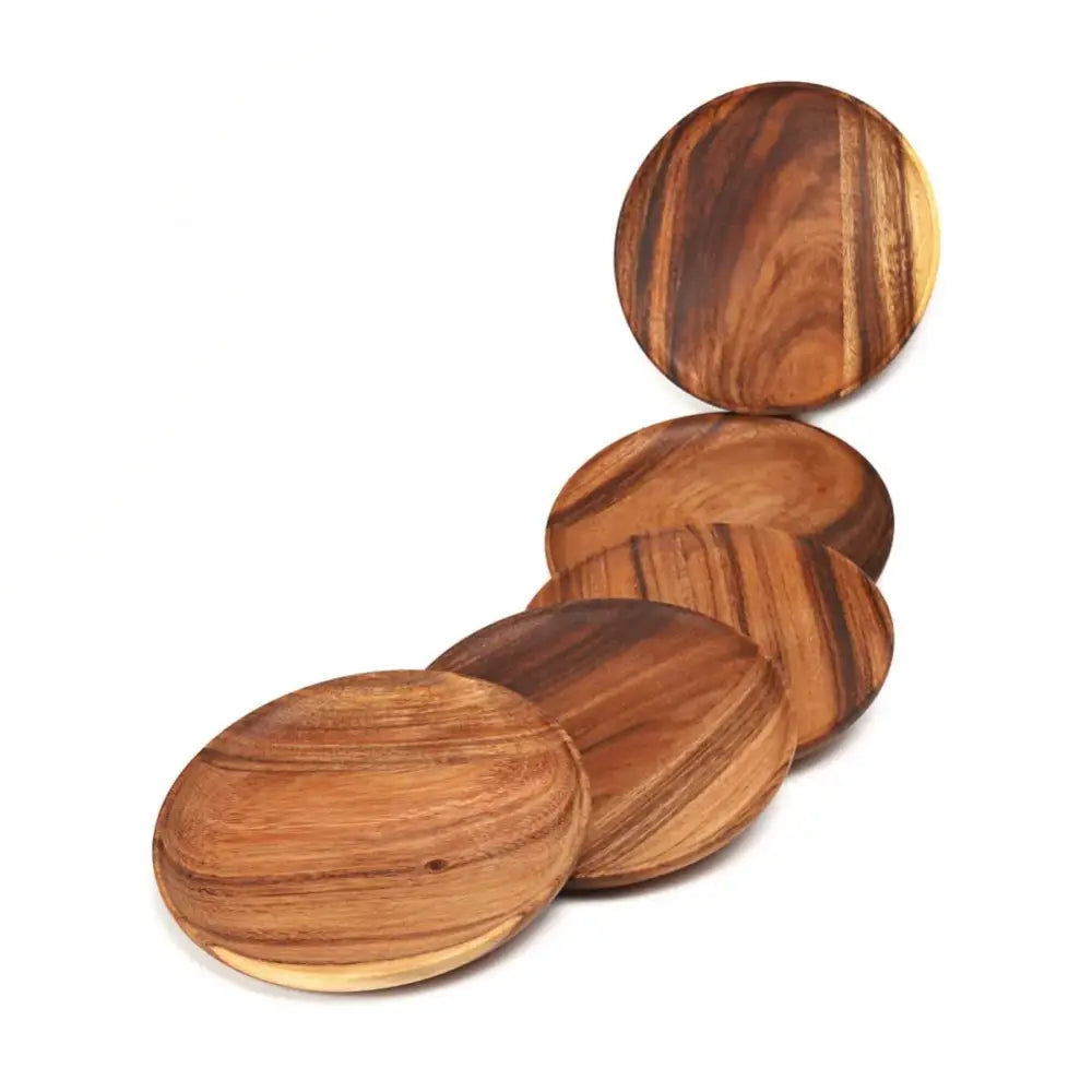 Set of five warm brown natural beech wooden round plates with visible wood grain patterns for kitchen and dining use
