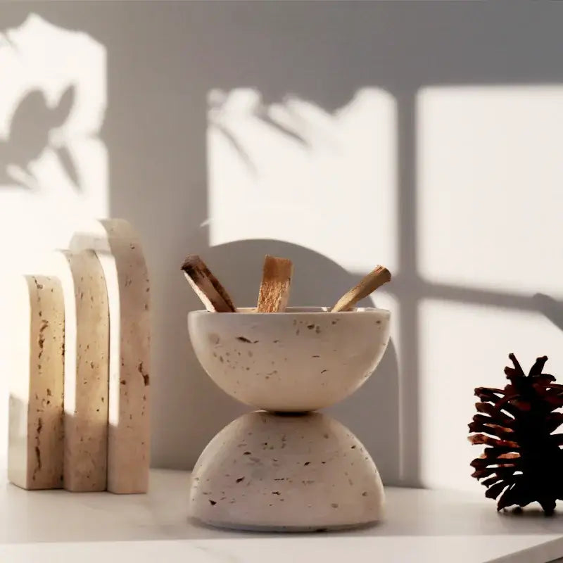 Cream-colored speckled beige travertine incense burner bowl with stacked design holding wooden sticks for decorbites beige travertine decor