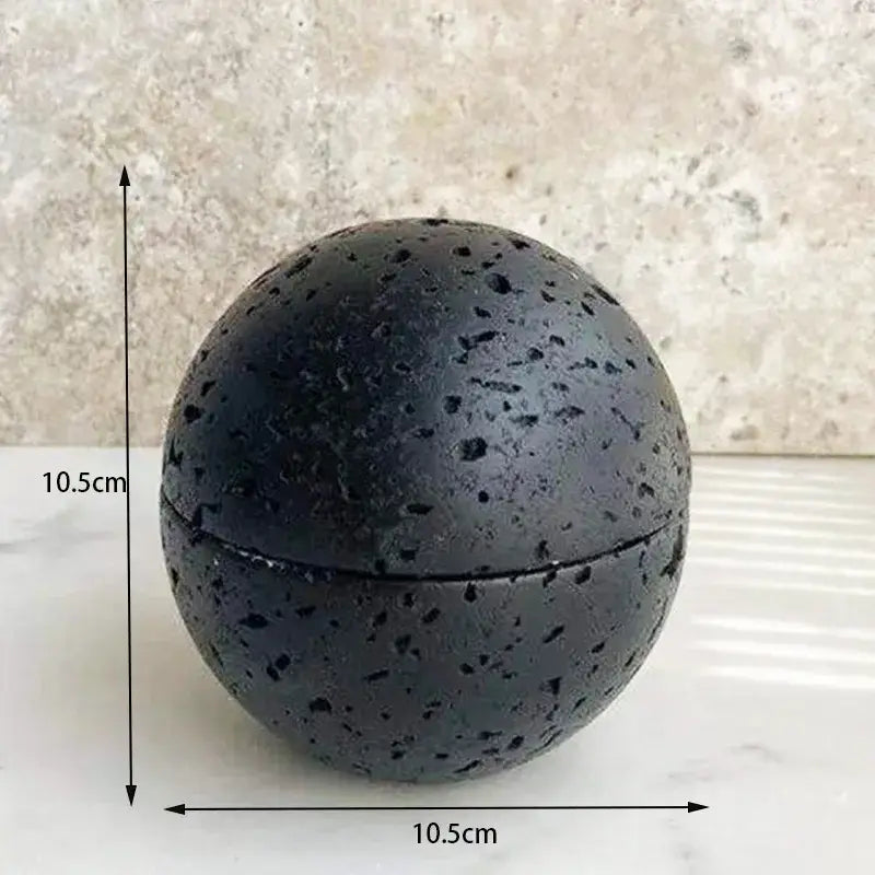 Matte black spherical lava stone incense burner with speckled texture and sealed lid for decorbites beige travertine decor