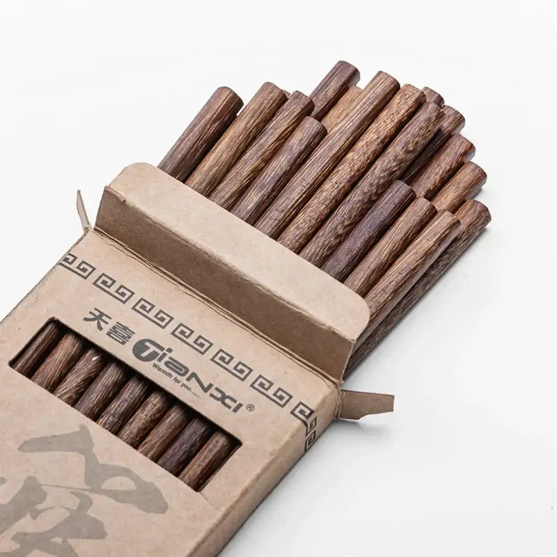 A natural dark brown healthy wood chopsticks set with wood grain finish in a tianxi cardboard box decorbites healthy wood