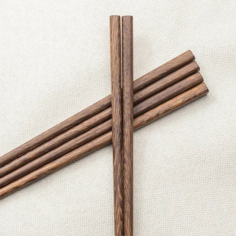 A pair of natural dark brown healthy wood chopsticks with wood grain finish from decorbites wood chopsticks set