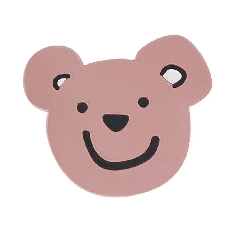 Pink bear-shaped pin with black embroidery displayed with natural lace bamboo woven coasters and storage basket set