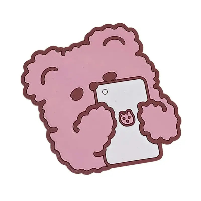 Pink curly-haired bear-shaped phone stand with pig face sticker alongside natural lace bamboo woven coasters storage basket set