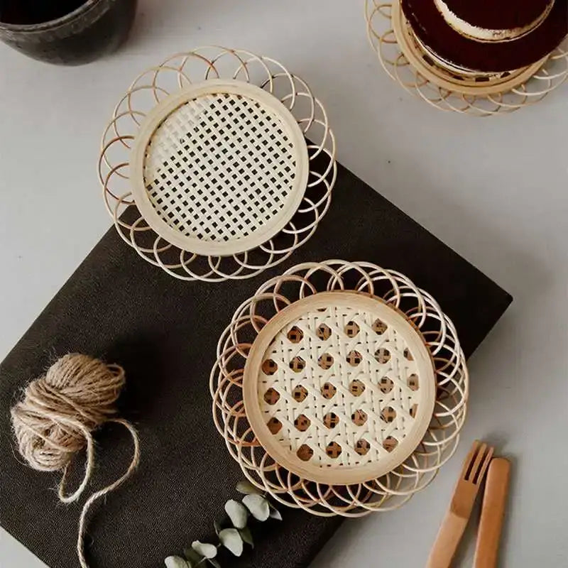 Two round off-white bamboo woven coasters with intricate patterns from a natural lace storage basket set for dining room use