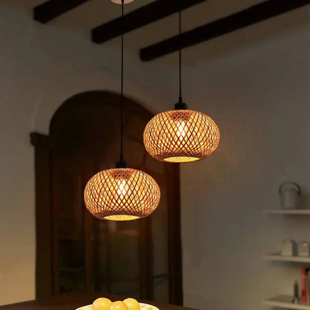 Two warm-toned natural lattice bamboo rattan pendant lights hang for dining room decorbites bamboo rattan lighting