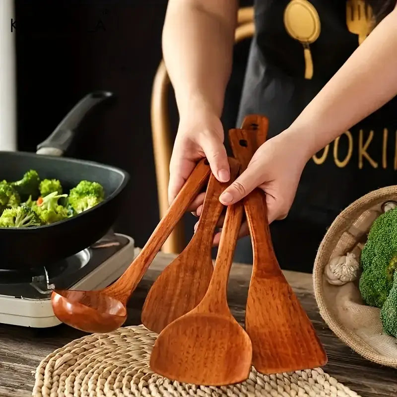 Natural polished 4-piece wooden kitchen utensil set with smooth surfaces including ladle and spatulas for cooking use