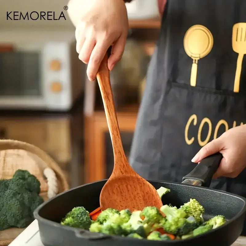 Natural polished wooden kitchen utensil set featuring a smooth light brown wooden spatula with visible grain