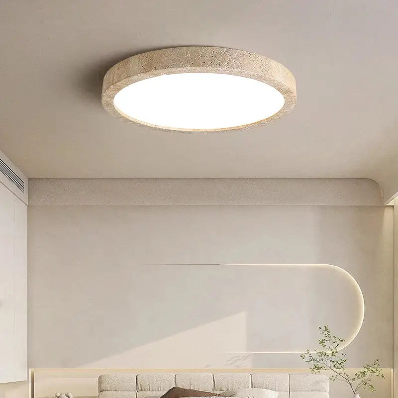 Natural travertine ellipse stone led ceiling light with textured beige frame and smooth white illuminated center for decorbites ellipse stone decor