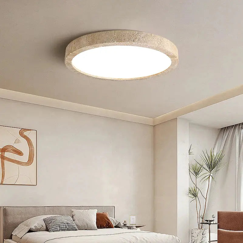 Circular ceiling light with a beige travertine ellipse stone led frame and bright white center for bedroom decorbites ellipse stone decor