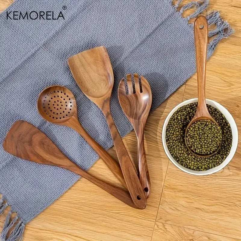 Set of five natural wooden kitchen utensils with smooth polished surfaces in warm brown wooden tableware set