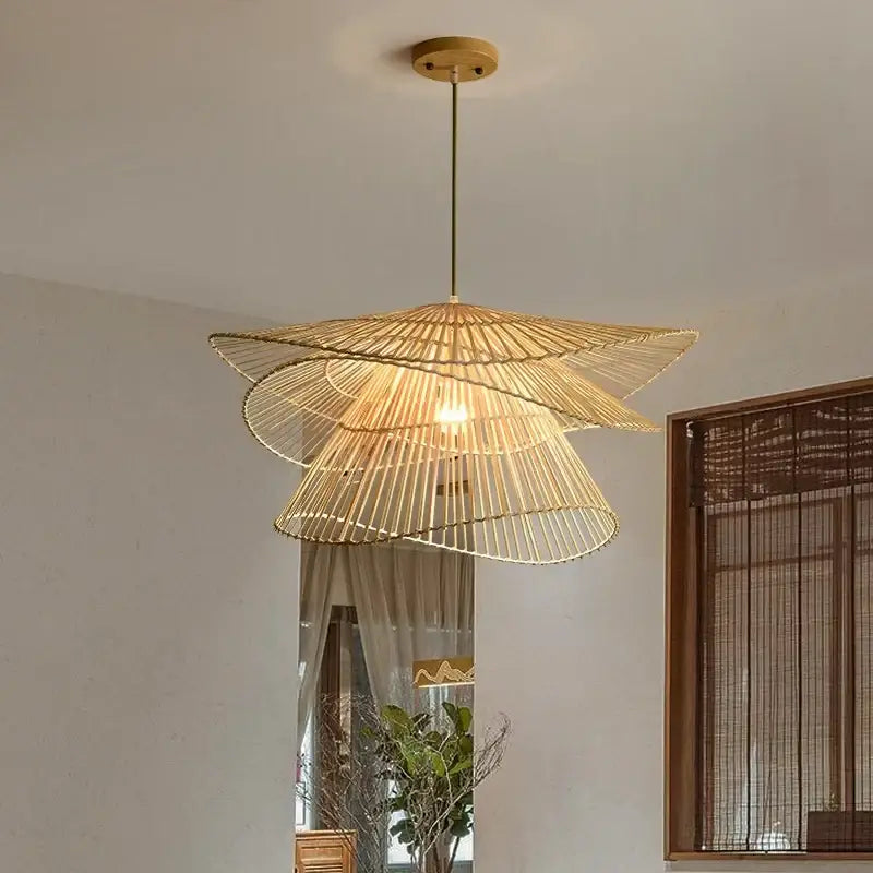 A warm-toned natural woven bamboo rattan pendant light with slender brass rod for dining room decorbites bamboo rattan
