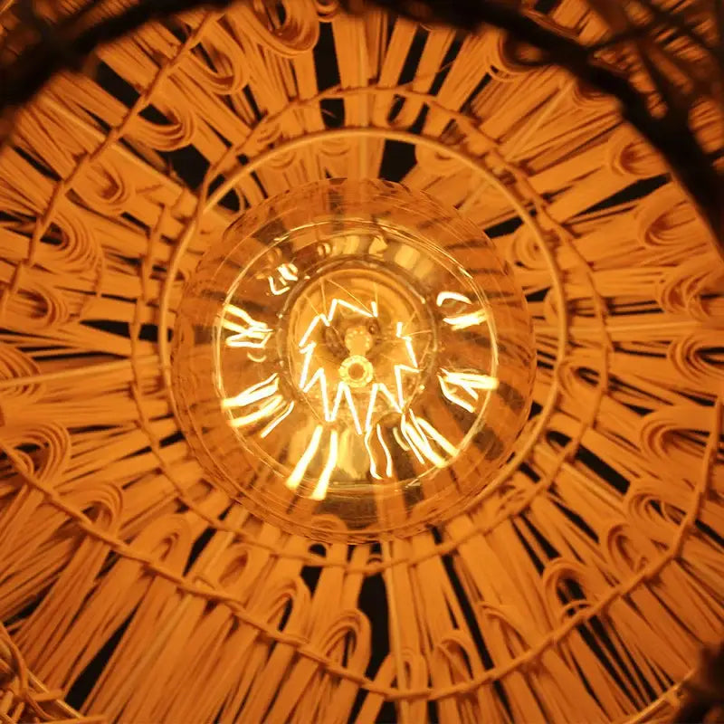 Warm-toned natural woven rattan pendant light with glowing Edison bulb for dining room rattan pendant lighting