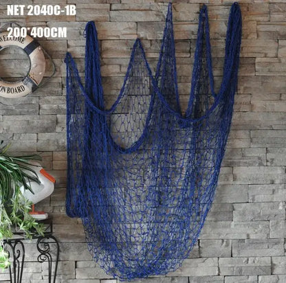 Nautical deep blue decorative fishing net with seashells hanging as a bedroom decor wall piece