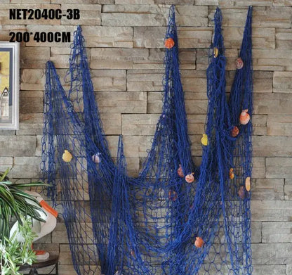 Nautical deep blue decorative fishing net wall hanging adorned with assorted seashells for bedroom decor