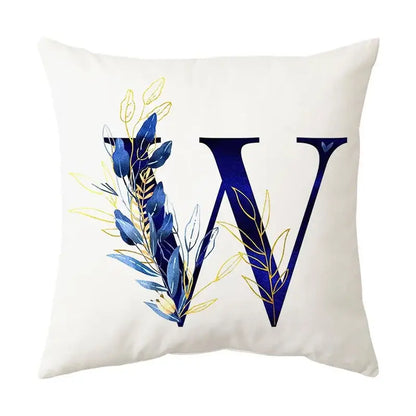 White throw pillow with bold navy blue letter w and blue alphabet flower foliage in navy and gold for bedroom decorbites decor