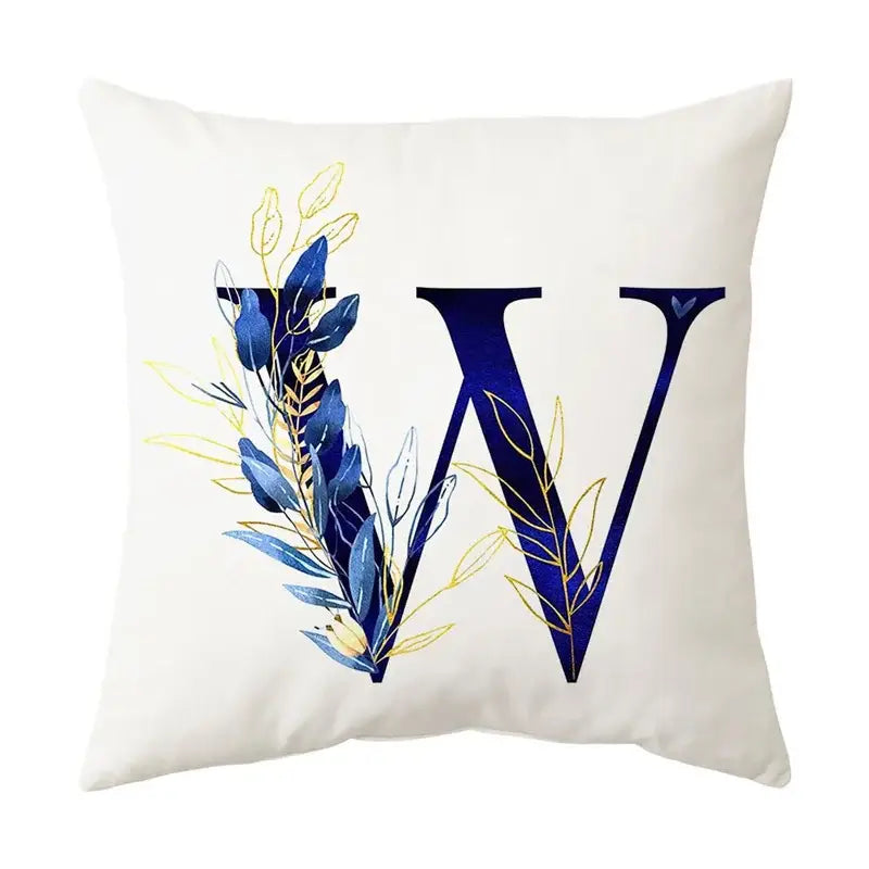 White throw pillow with bold navy blue letter w and blue alphabet flower foliage in navy and gold for bedroom decorbites decor