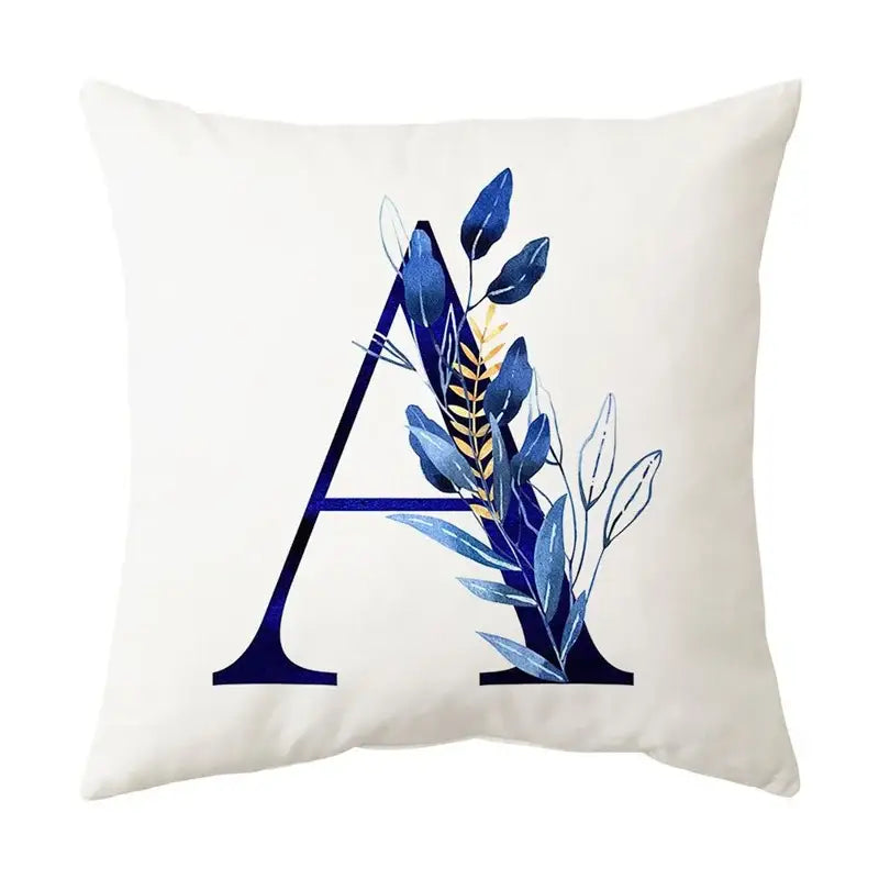 Cream-colored cushion with bold navy blue alphabet flower letter a decorated with blue and gold foliage for decorbites blue alphabet decor