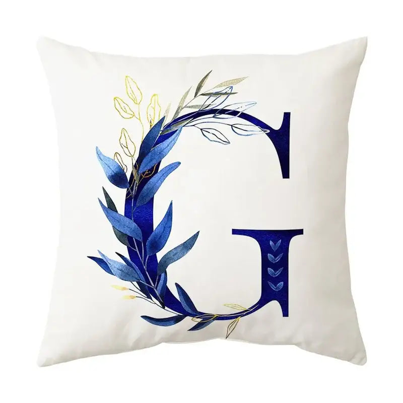 White throw pillow with navy blue letter g featuring blue alphabet flower foliage in navy and gold for bedroom decorbites decor