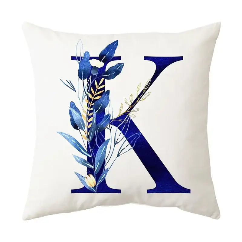 Cream-colored cushion with navy and gold alphabet flower letter k featuring decorbites blue alphabet botanical design