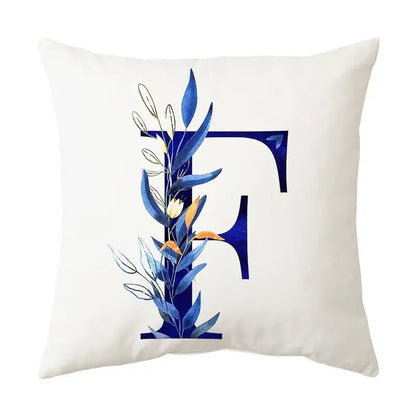 White throw pillow with bold navy blue alphabet flower letter f and delicate blue and gold decorbites blue alphabet design